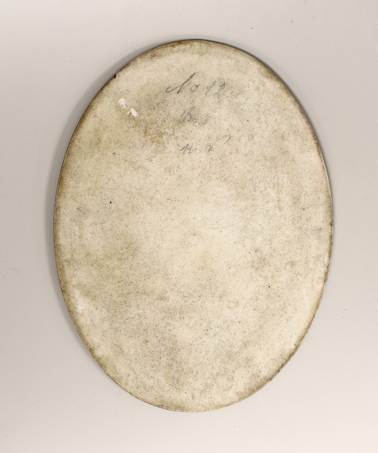 A 19th century oval painted porcelain plaque of a girl, 17 x 13cm